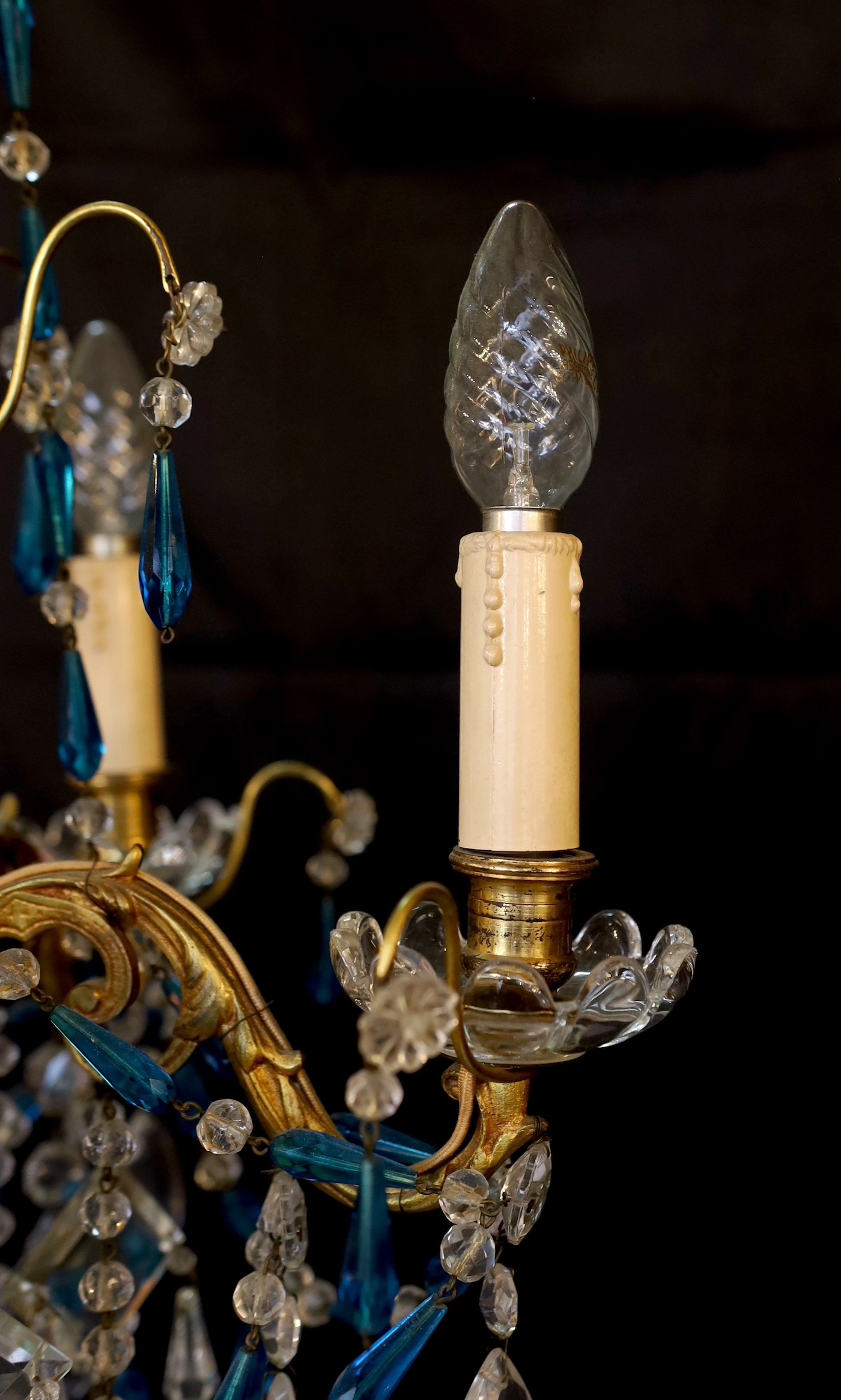 An early 20th century French gilt brass clear and blue glass four light chandelier, drop 80cm. width 40cm